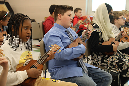  Students playing ukulele in music room